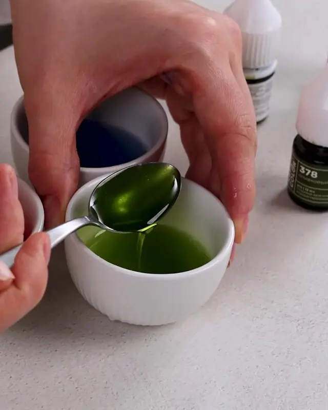 Adding green gel color to a small bowl of gelatin