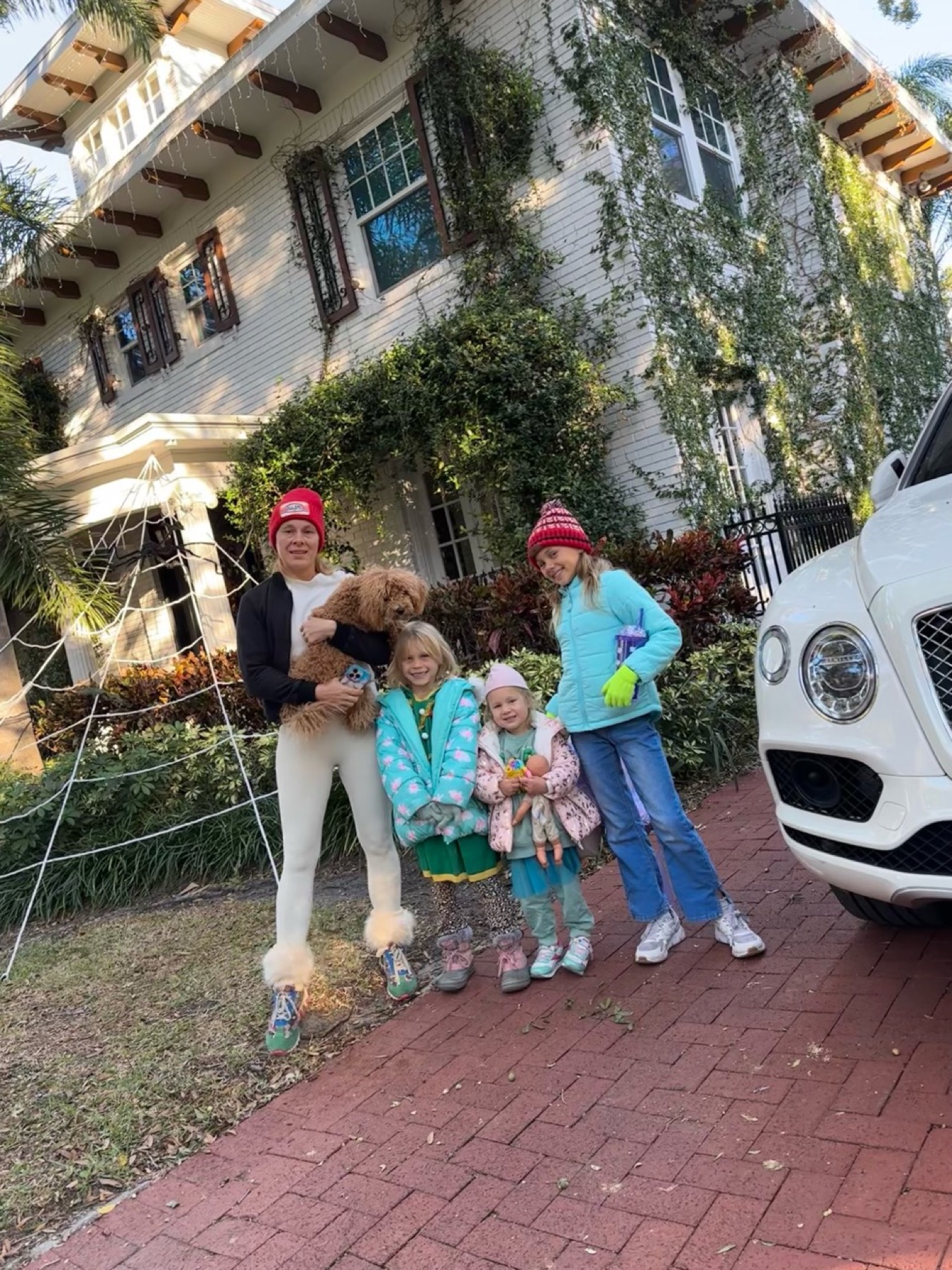 Dmitry's wife, daughters, and dog at the family home beside the Bentley