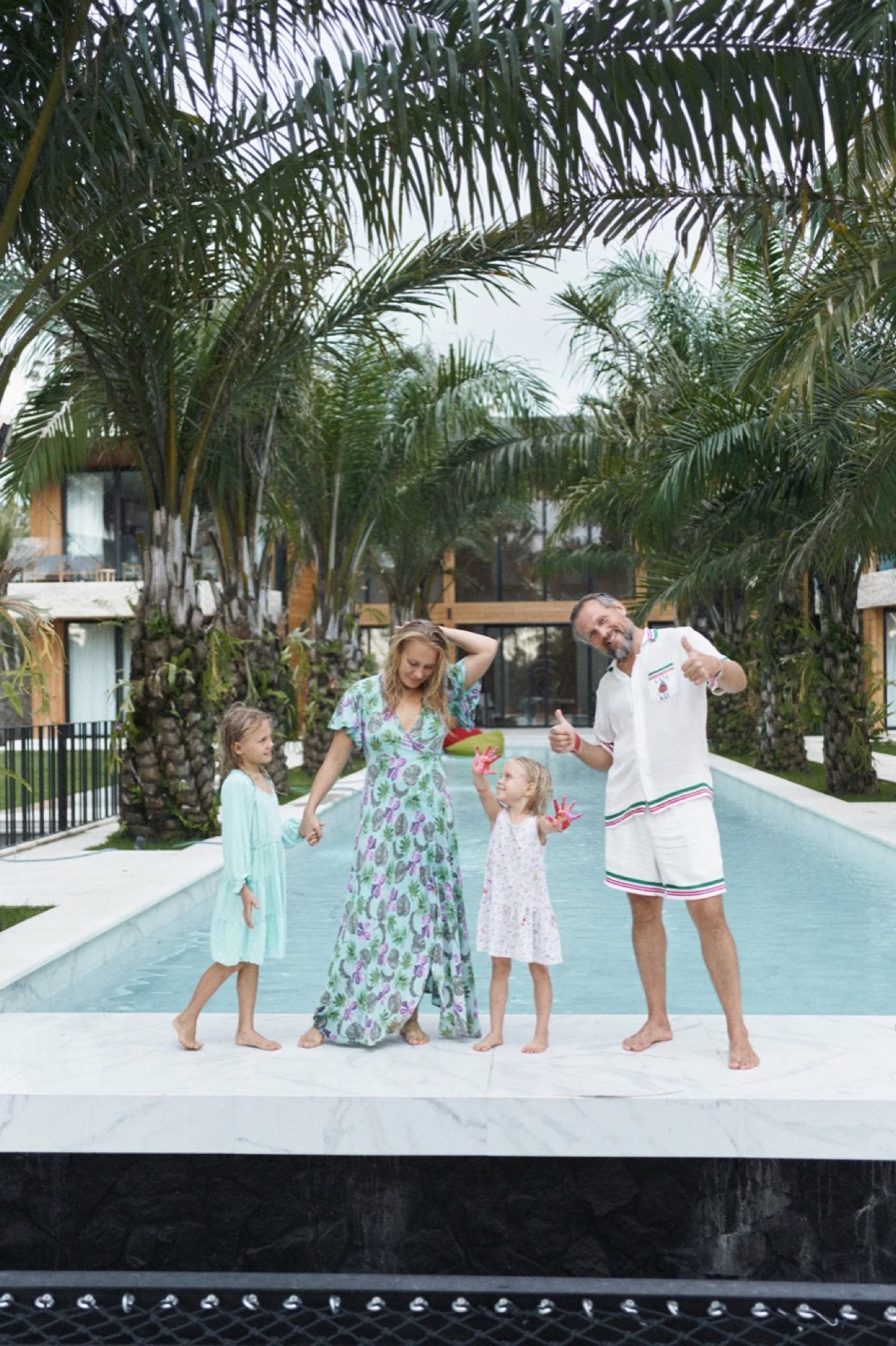 Dmitry with his family beside the villa pool