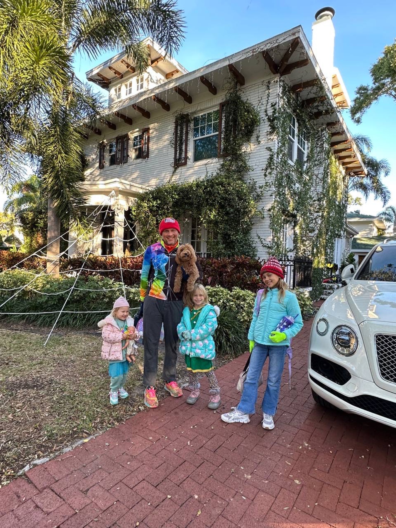 Dmitry with his daughters and dog at the family home beside the Bentley
