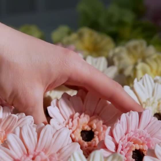 Hands holding a molded gerbera flower
