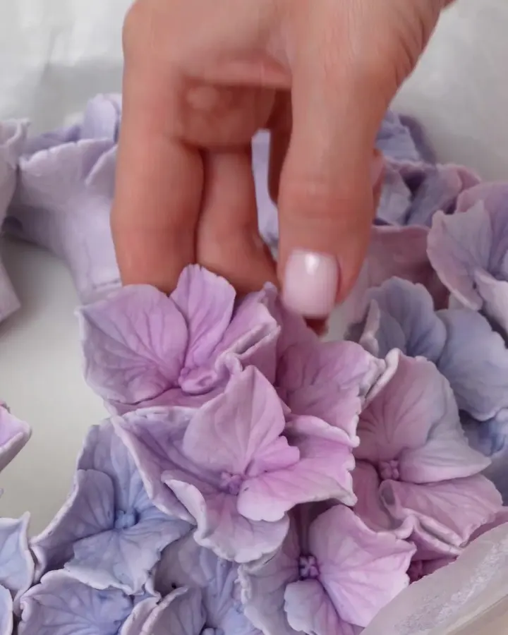 Arranging edible hydrangea petals into a bouquet