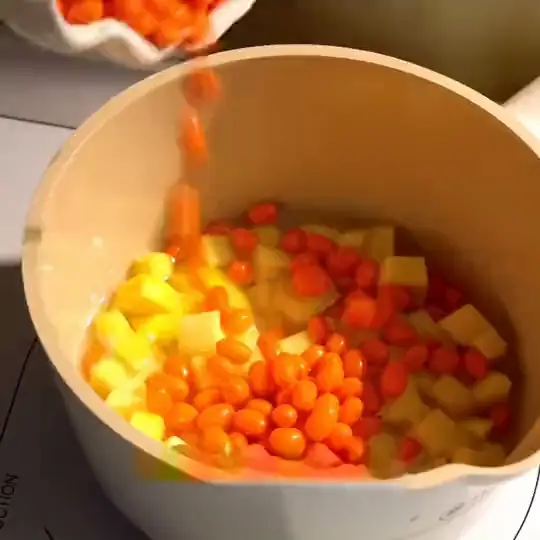 Fresh berries and mango going into the pan for the fruit base