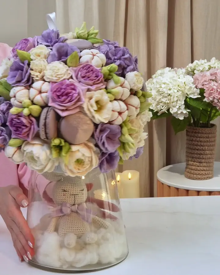 A finished bouquet of edible flowers in a glass vase